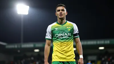 A photorealistic image of an anonymous Norwich City player, aged 25-30, wearing a green and yellow jersey, with a white...