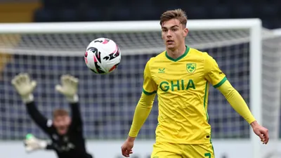 A photorealistic image of an anonymous Norwich City Under-18s player in a yellow and green kit, with a clean, smooth...