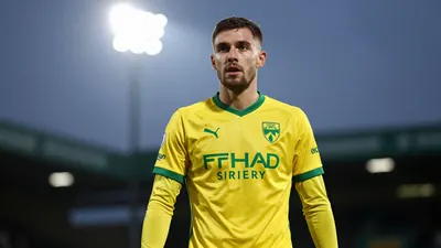 A photorealistic image of an anonymous Norwich City player in a yellow and green kit, taken from the waist-up, with the...