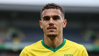Photorealistic head-and-shoulders of a 25-year-old Norwich City player in a solid yellow shirt, smooth fabric texture