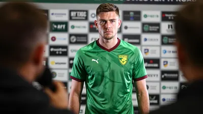 A medium shot of a 28-year-old, 5'10" tall, athletic build, Darlin Yongwa, Norwich City's newly signed centre-back...