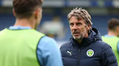 A photo of Philippe Clement, Norwich City's manager, speaking to a player during a training session, with a focus on his...
