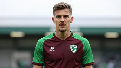 A determined 28-year-old Norwich City midfielder, wearing the green and dark red home kit with the Canaries' crest on the...